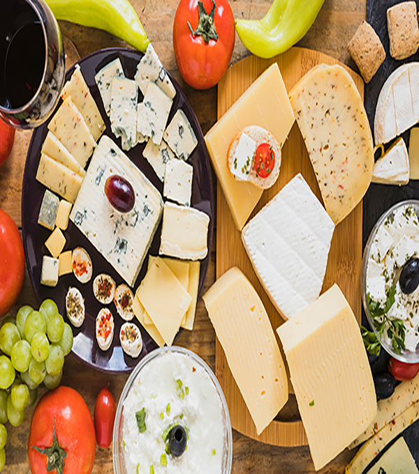 cheese-blocks-slices-with-tomatoes-grapes-green-chili-pepper-table