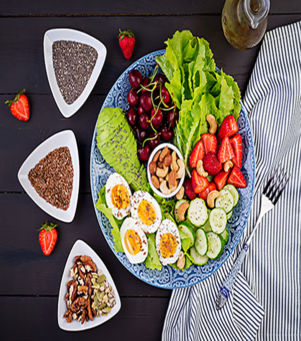 plate-with-paleo-diet-food-boiled-eggs-avocado-cucumber-nuts-cherry-strawberries-paleo-breakfast-top-view